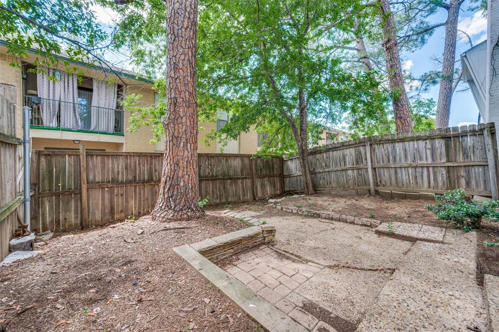 412 Hollyhill Lane Denton, TX 76205 - Photo 13 of 15 a view of a backyard with wooden fence and a large tree
