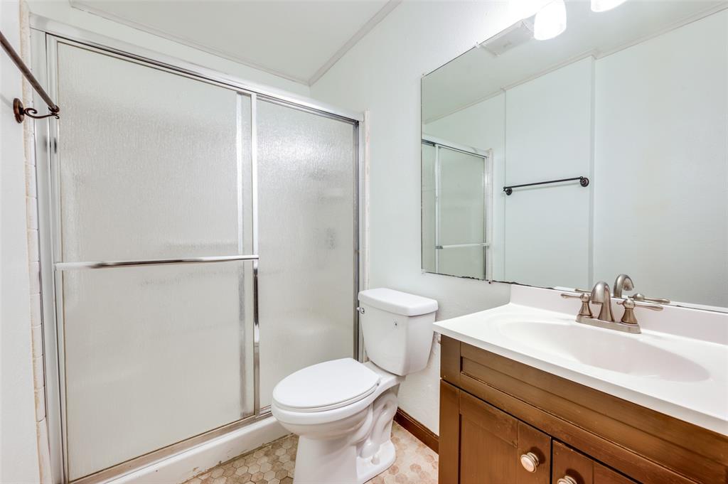 412 Hollyhill Lane Denton, TX 76205 - Photo 10 of 15 a bathroom with a sink a toilet and shower