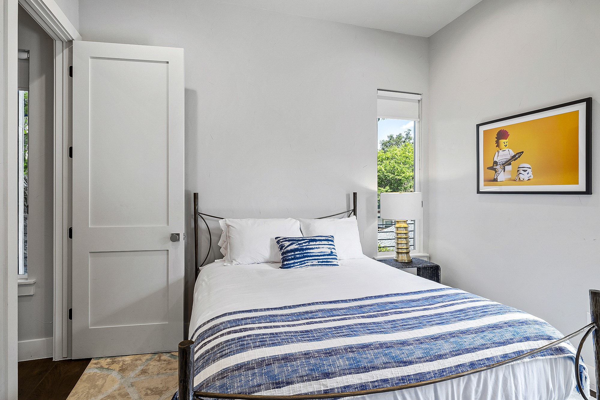 2414 Kinney Road Austin, TX 78704 - Photo 19 of 40 a bedroom with a bed and a painting on the wall