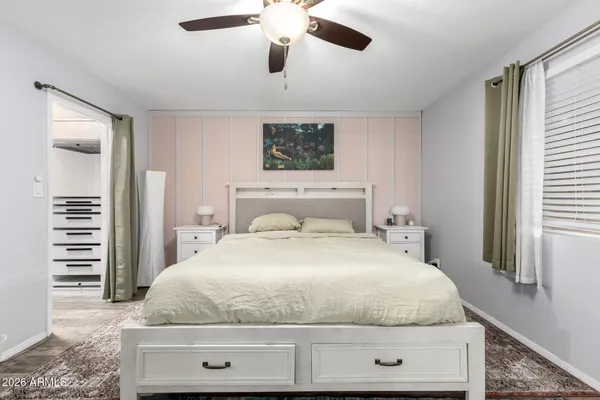 a bedroom with a bed and a window