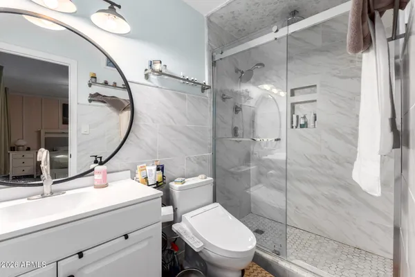 a bathroom with a sink toilet and shower