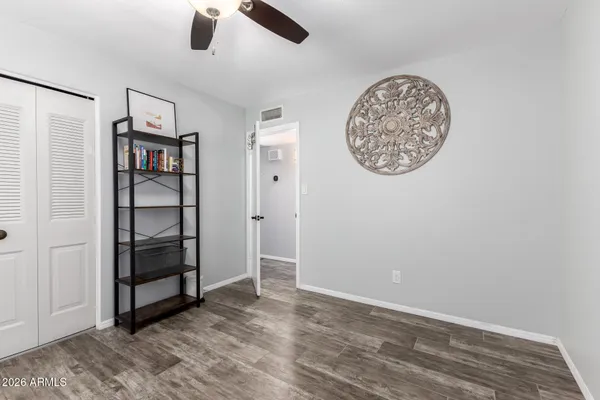 an empty room with a walk in closet and a window