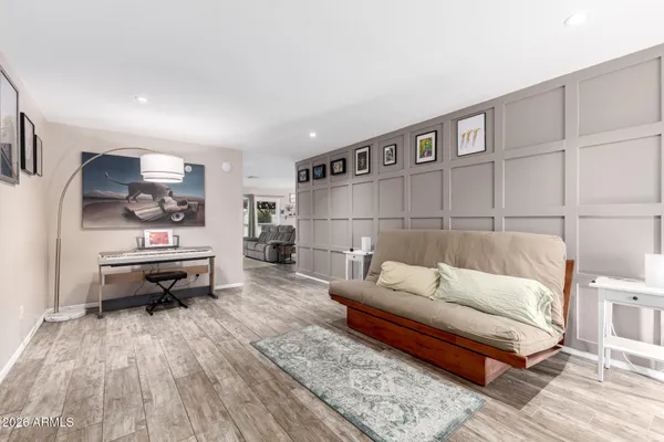 a living room with furniture and a wooden floor