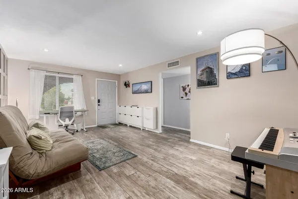 a living room with furniture and wooden floor