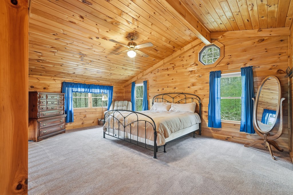 238 Cedar Ridge Road Cherry Log, GA 30522 - Photo 15 of 22 a spacious bedroom with a bed and a table in it