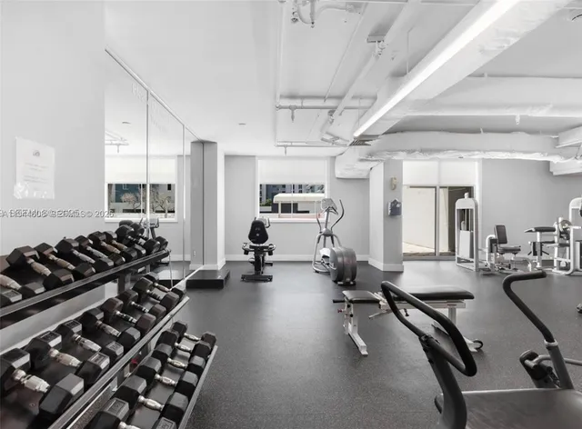 a room with gym equipment and a large window