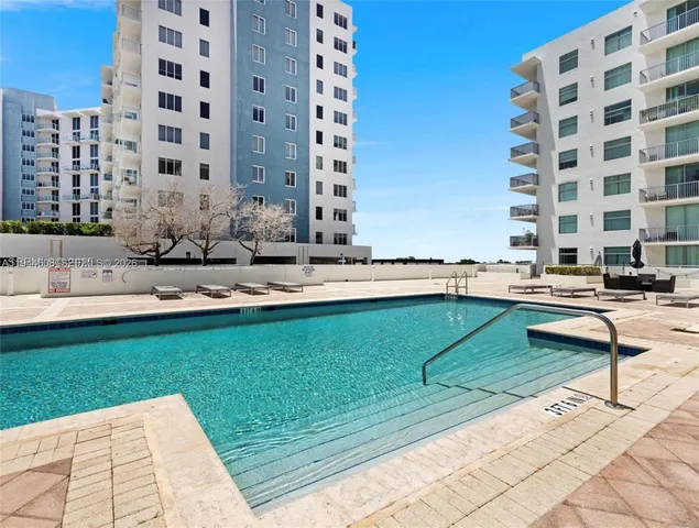 a swimming pool with outdoor seating and yard