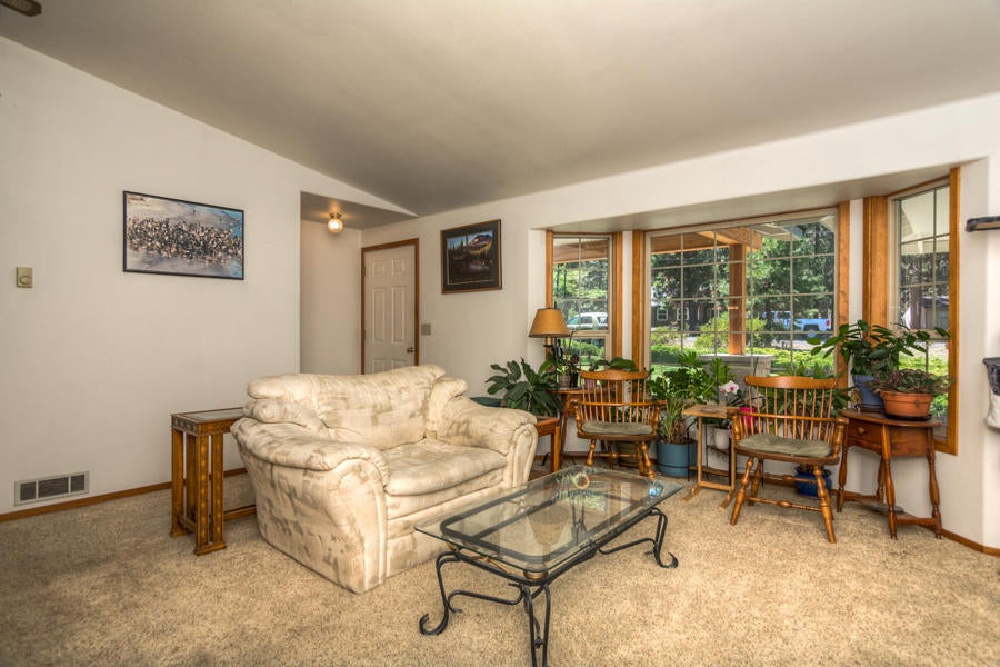 19116 Kiowa Road Bend, OR 97702 - Photo 15 of 38 Living room has ceiling fan & bay window
