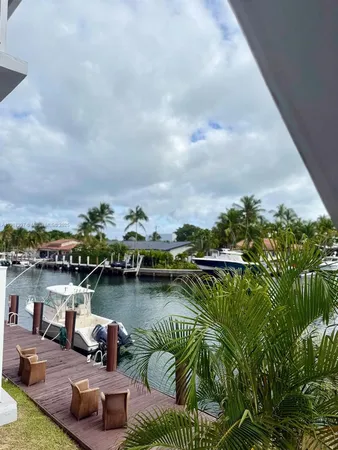 a view of a lake with houses in back