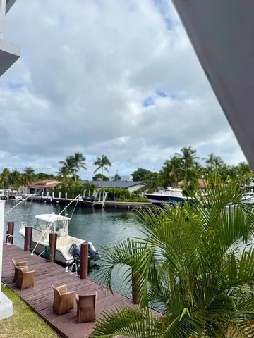 a view of a lake with houses in back