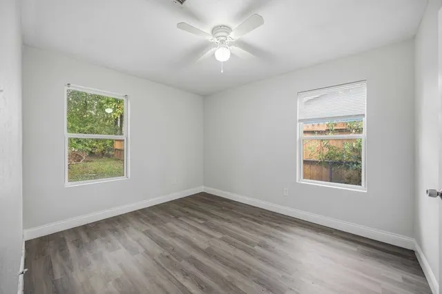 wooden floor in an empty room with a window