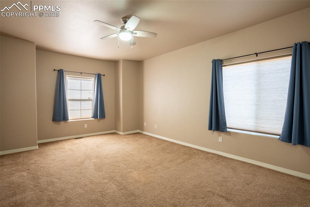 1985 Reed Grass Way Colorado Springs, CO 80915 - Photo 16 of 37 an empty room with windows and closet