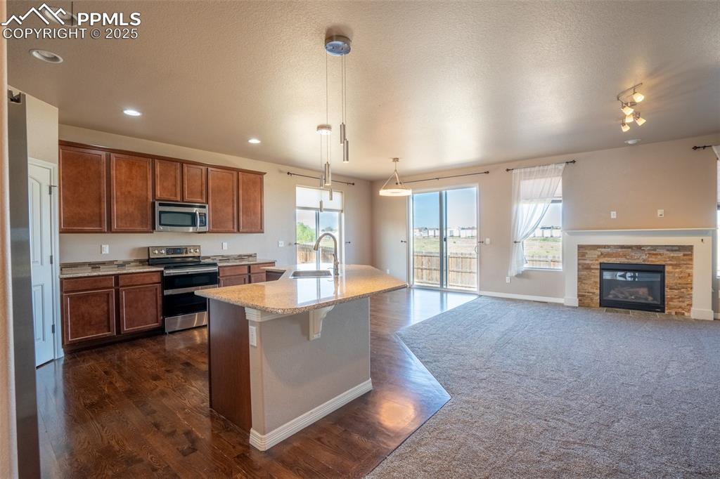 1985 Reed Grass Way Colorado Springs, CO 80915 - Photo 2 of 37 a large kitchen with stainless steel appliances kitchen island granite countertop a large counter top stainless steel appliances and cabinets