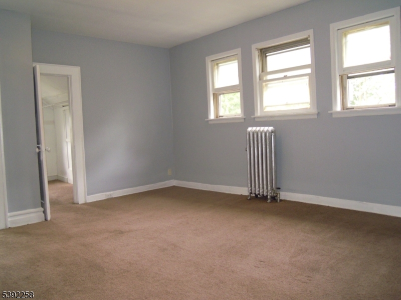 56 Pine Grove Terrace, Unit UPR Newark, NJ 07106 - Photo 6 of 7 an empty room with a window