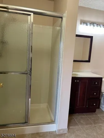 a bathroom with a shower sink and mirror