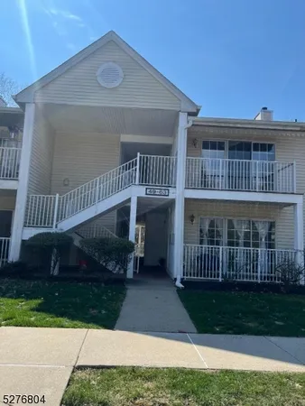 a view of a house with a yard and deck