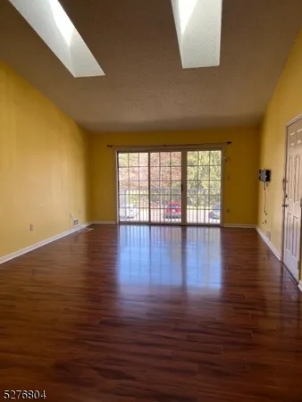 a view of wooden floor and windows in a room