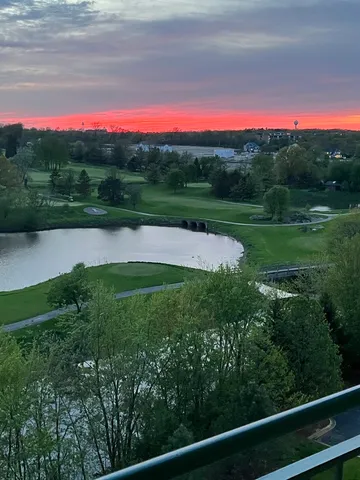 a view of a lake with sunset in background