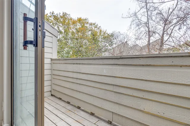 a view of a house with a large window and tree