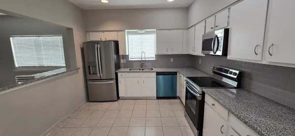a kitchen with a sink stove and refrigerator