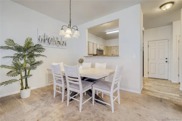 a view of a dining room with furniture and a chandelier