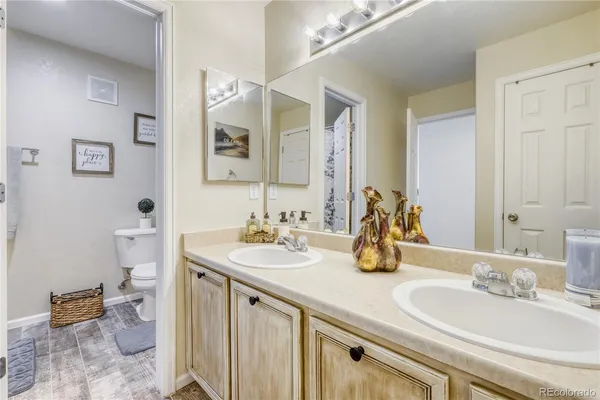 a bathroom with a double vanity sink and a mirror
