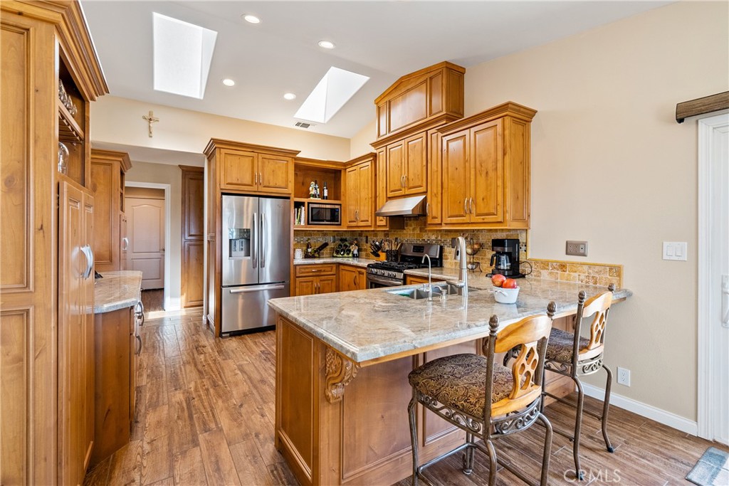 2255 Lothar Lane Templeton, CA 93465 - Photo 11 of 41 a kitchen with a table chairs refrigerator and cabinets