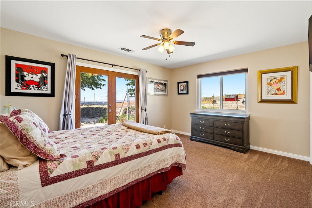 2255 Lothar Lane Templeton, CA 93465 - Photo 24 of 41 a bedroom with a bed and a chandelier
