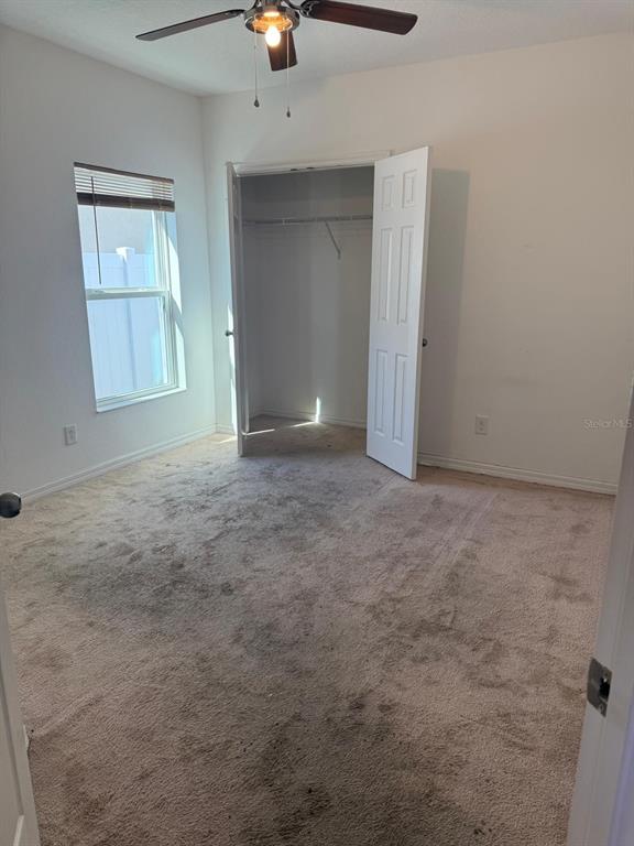 622 Samuel Place Davenport, FL 33837 - Photo 11 of 64 an empty room with windows and closet