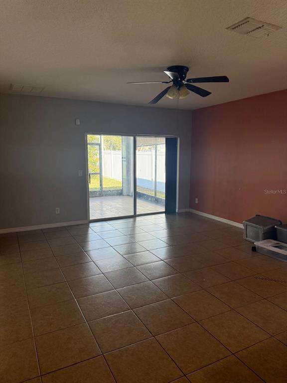 622 Samuel Place Davenport, FL 33837 - Photo 14 of 64 a view of an empty room with a window
