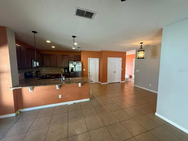 a kitchen with a sink and a refrigerator