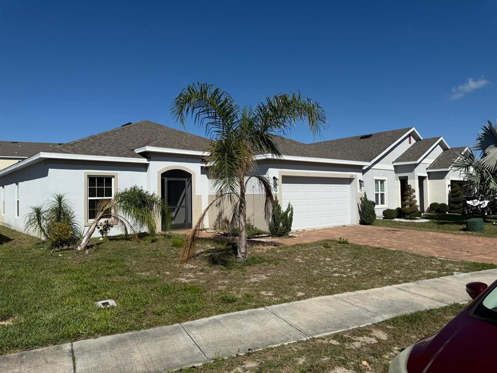 622 Samuel Place Davenport, FL 33837 - Photo 2 of 64 a front view of a house with a yard