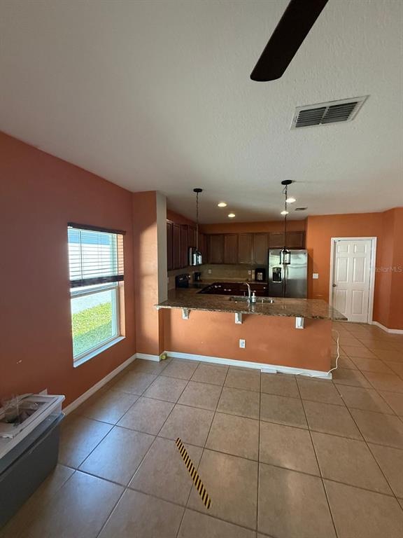 622 Samuel Place Davenport, FL 33837 - Photo 22 of 64 a view of an empty room with kitchen and window