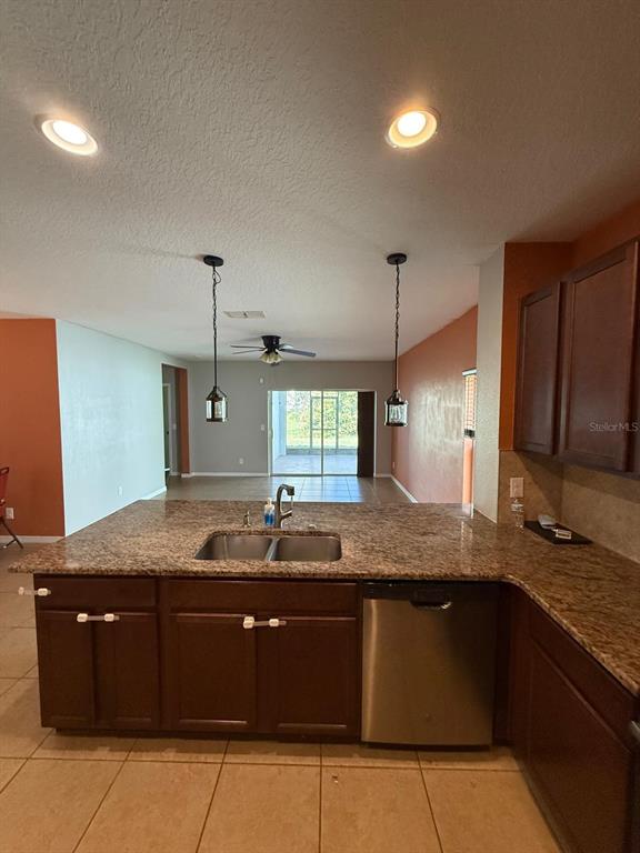 622 Samuel Place Davenport, FL 33837 - Photo 23 of 64 a kitchen with a sink and a refrigerator
