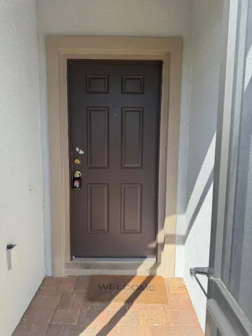a view of a hallway with furniture and a mirror