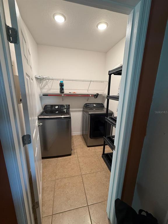 622 Samuel Place Davenport, FL 33837 - Photo 44 of 64 a kitchen with a sink stainless steel appliances and cabinets