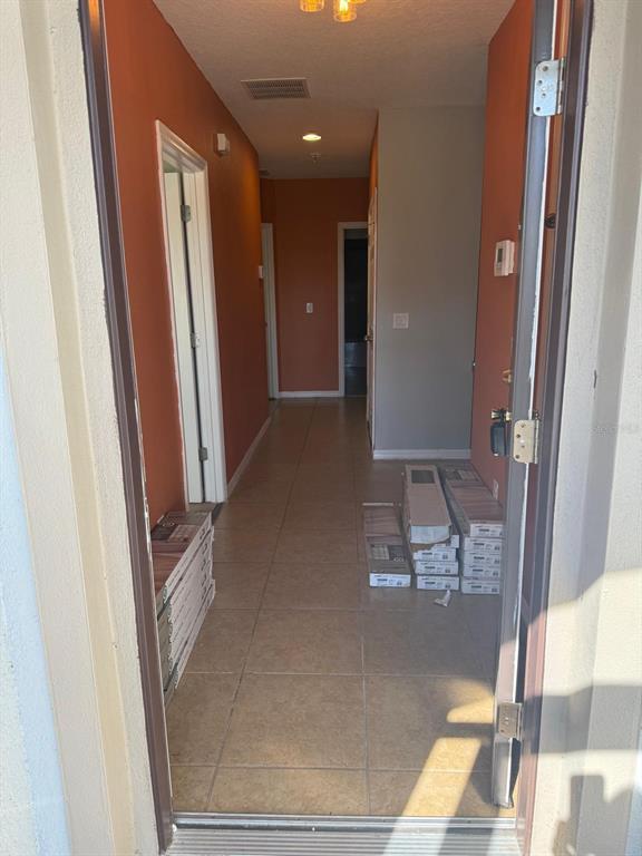 622 Samuel Place Davenport, FL 33837 - Photo 5 of 64 a view of a hallway with furniture and a mirror