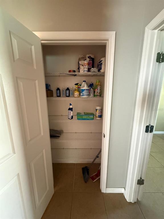 622 Samuel Place Davenport, FL 33837 - Photo 58 of 64 a room with rack and white doors