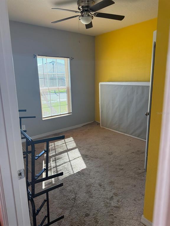 622 Samuel Place Davenport, FL 33837 - Photo 6 of 64 a view of an empty room with a window