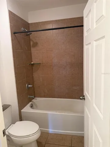 a view of an empty room with a ceiling fan