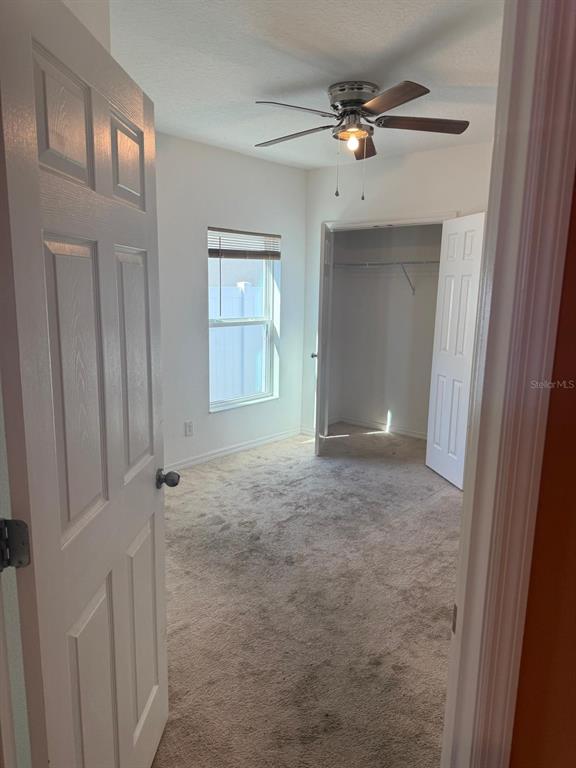 622 Samuel Place Davenport, FL 33837 - Photo 10 of 64 a view of an empty room with a ceiling fan