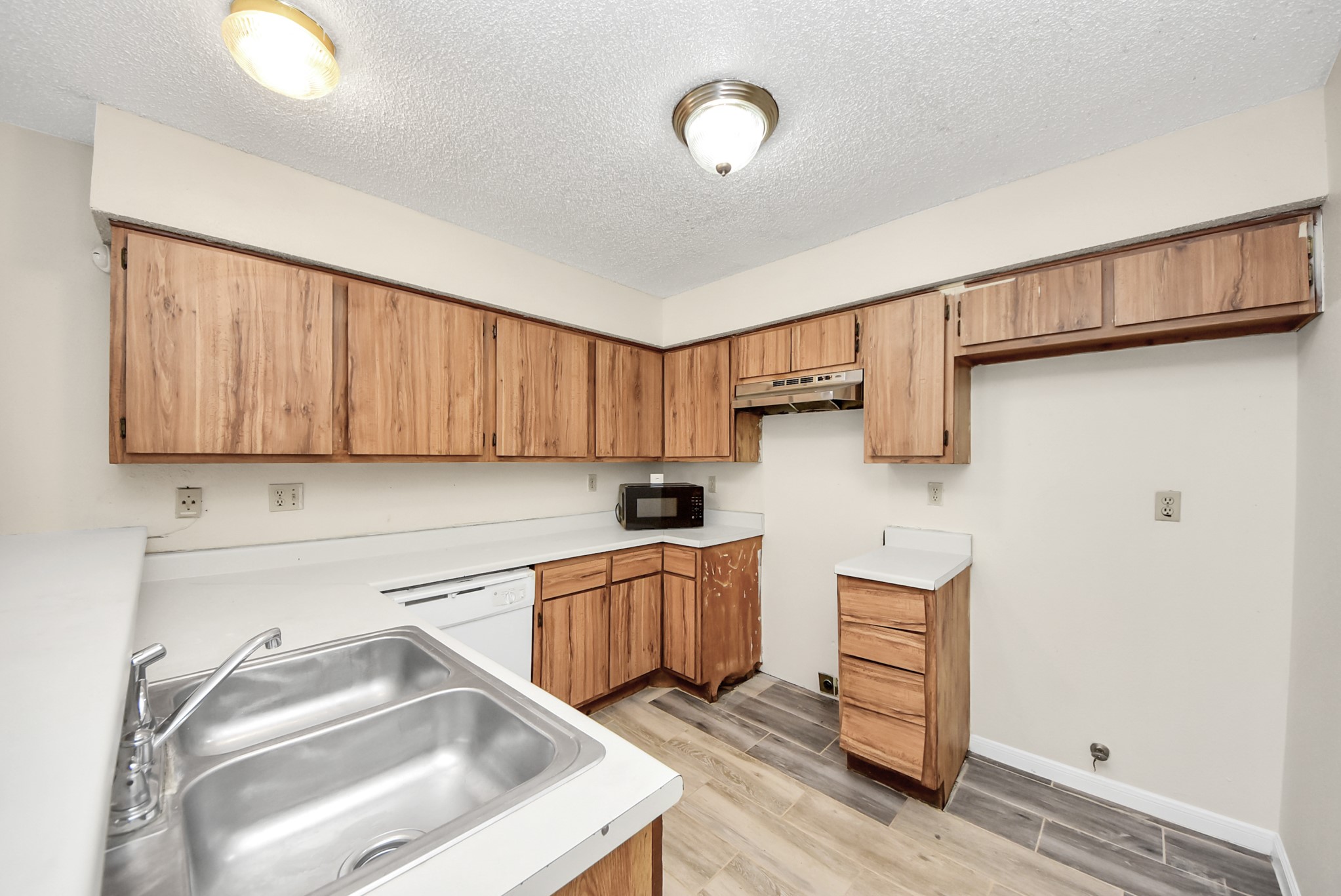 12232 Copper Tree Pvt Lane, Unit 122 Houston, TX 77035 - Photo 11 of 41 a kitchen with cabinets a sink and a stove top oven