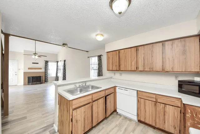 a kitchen with a sink cabinets and window