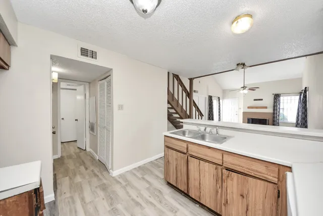 a kitchen with cabinets a sink and appliances