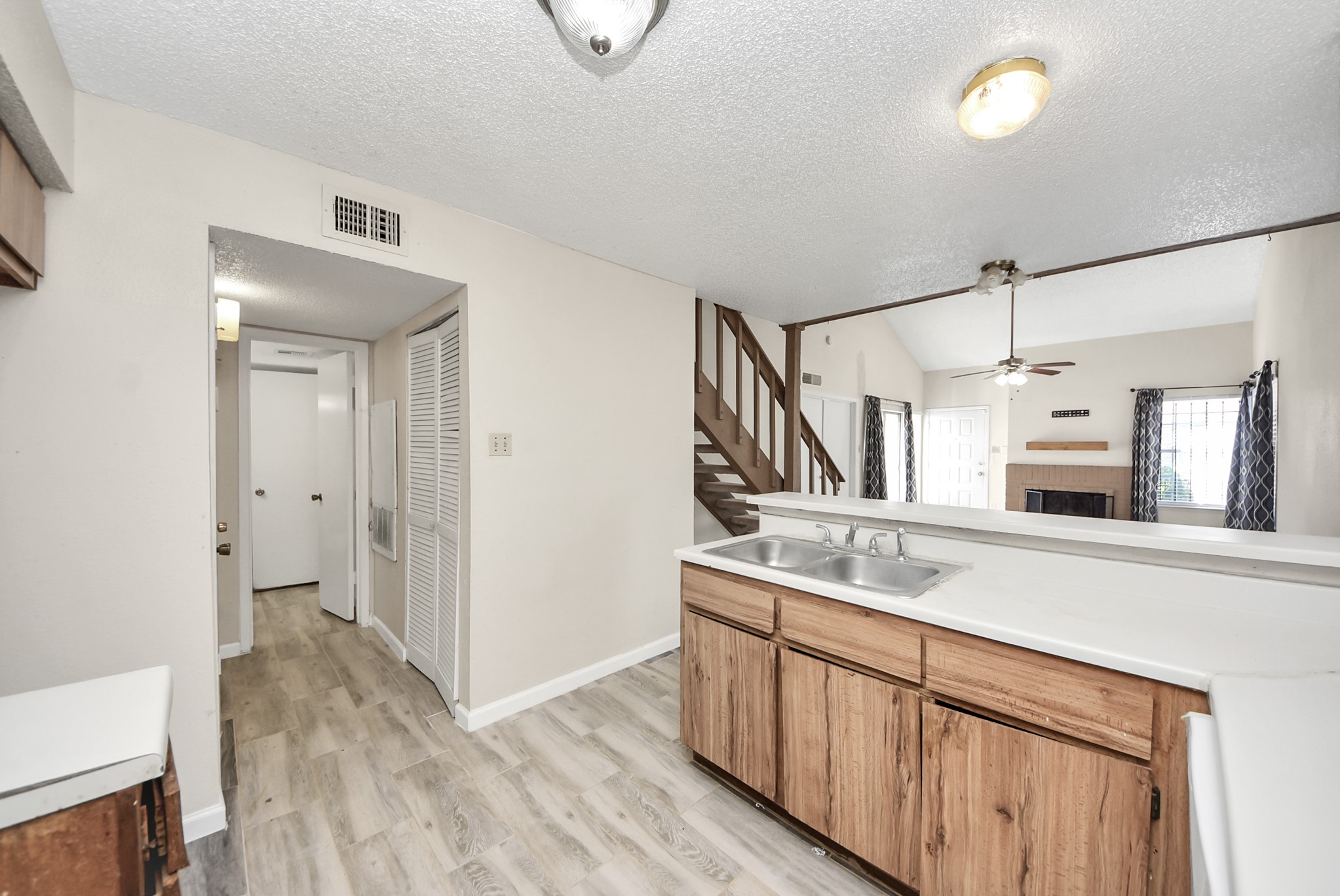 12232 Copper Tree Pvt Lane, Unit 122 Houston, TX 77035 - Photo 15 of 41 a kitchen with cabinets a sink and appliances