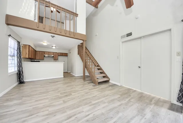 a view of an entryway with wooden floor