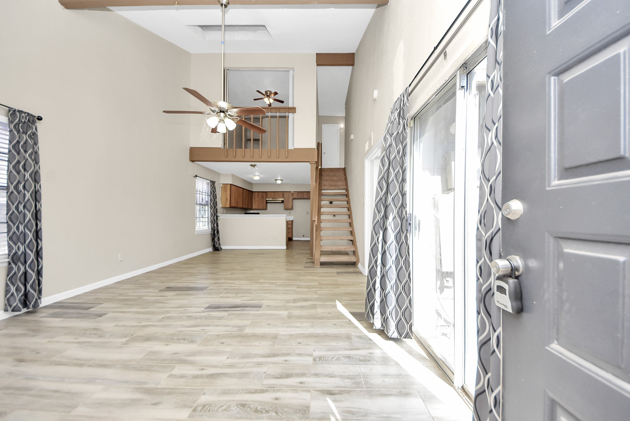 12232 Copper Tree Pvt Lane, Unit 122 Houston, TX 77035 - Photo 2 of 41 a view of a livingroom with a fireplace a chandelier furniture and windows