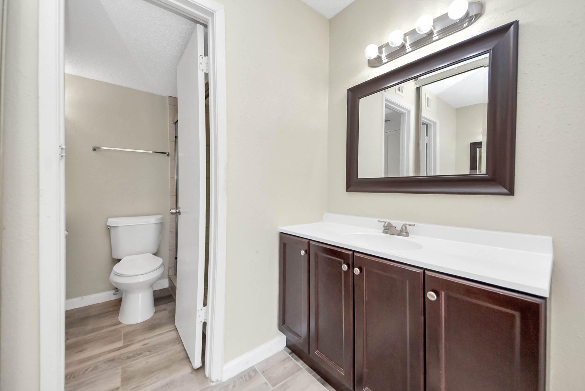 12232 Copper Tree Pvt Lane, Unit 122 Houston, TX 77035 - Photo 22 of 41 a bathroom with a toilet sink and mirror