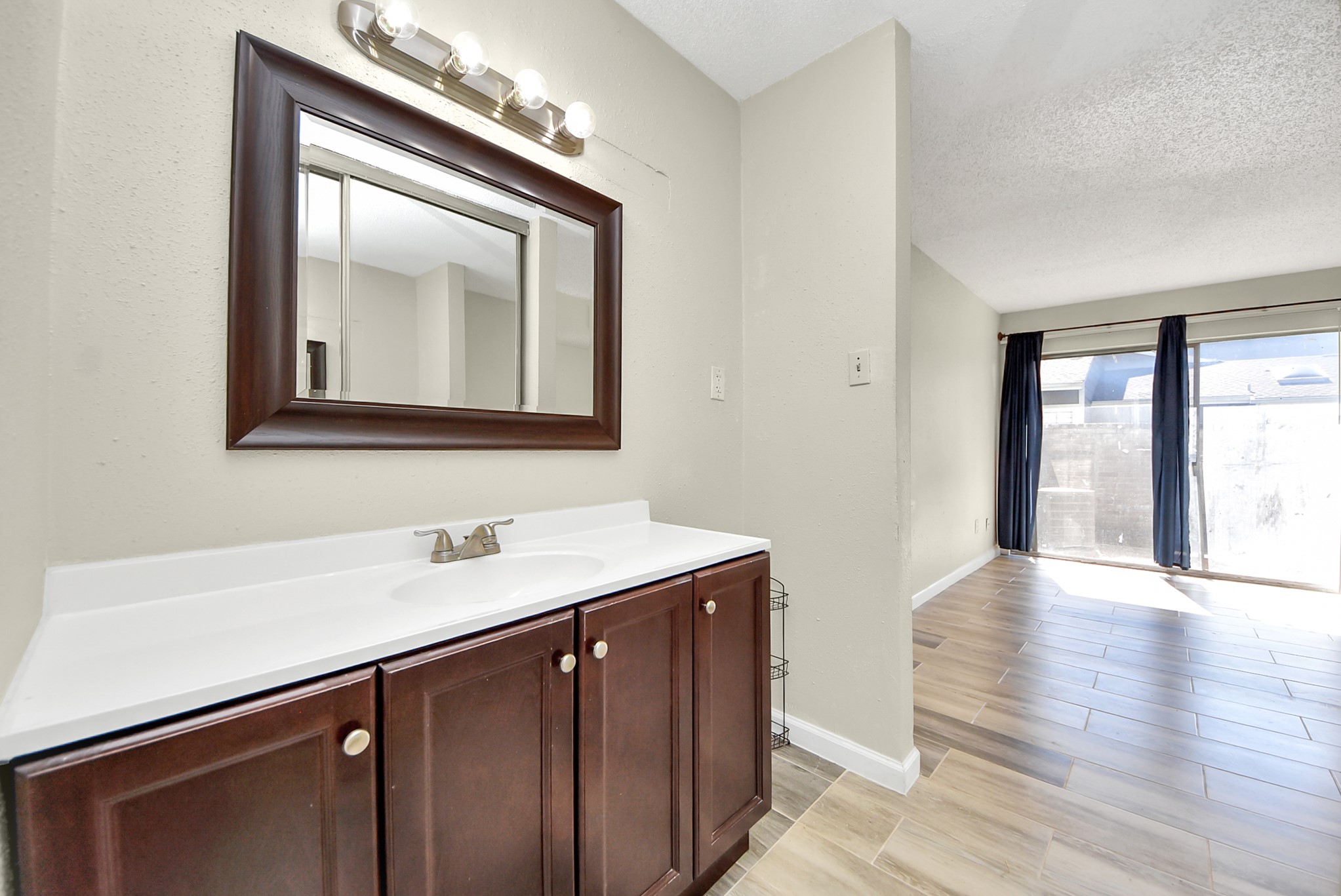 12232 Copper Tree Pvt Lane, Unit 122 Houston, TX 77035 - Photo 25 of 41 a bathroom with a sink a vanity and a large mirror
