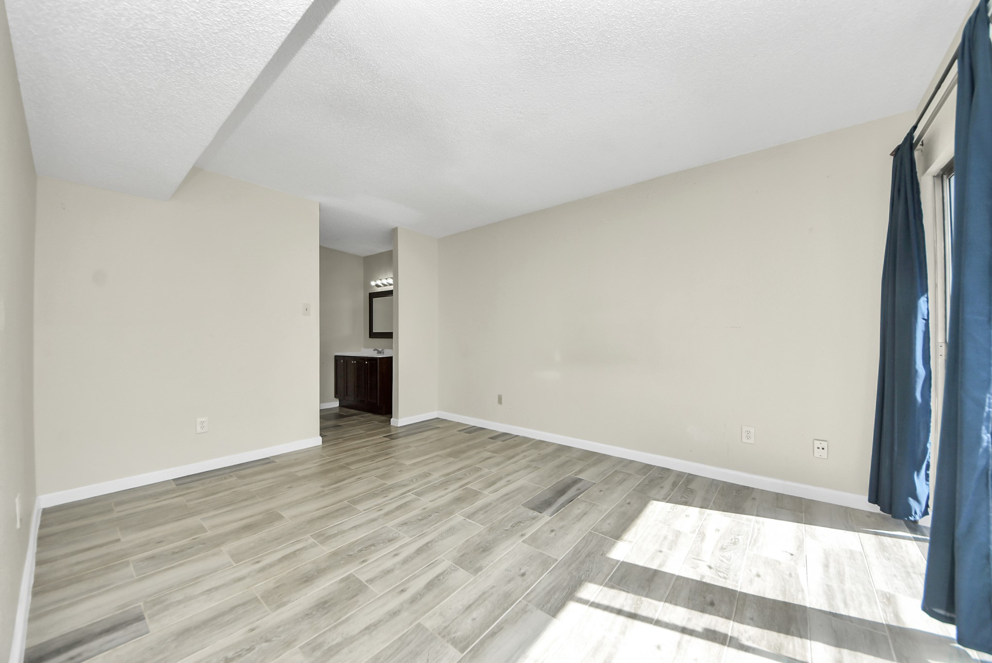 12232 Copper Tree Pvt Lane, Unit 122 Houston, TX 77035 - Photo 26 of 41 a view of an empty room and wooden floor